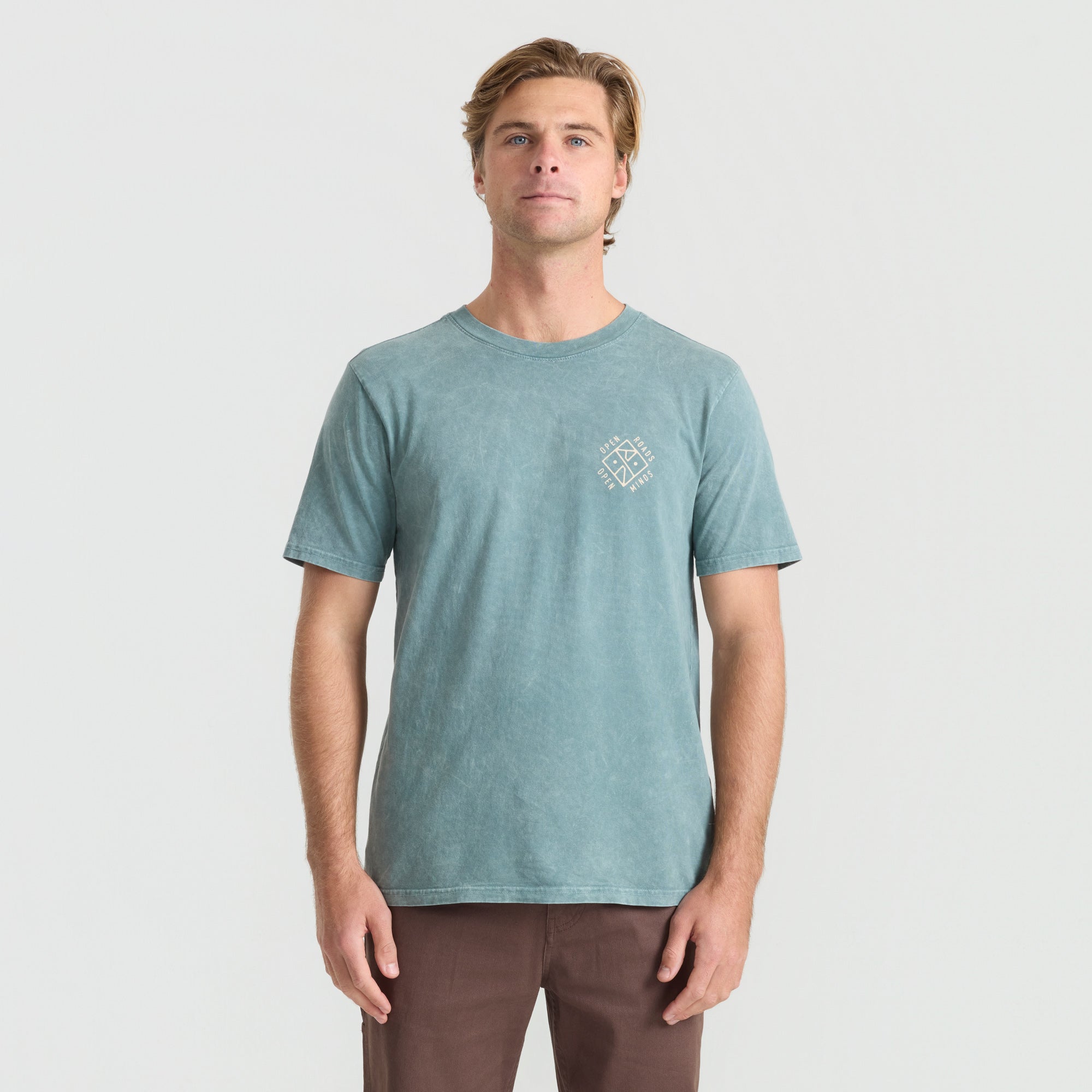 Man wearing a rugged denim active shirt by Roark, ideal for adventure and outdoor activities.