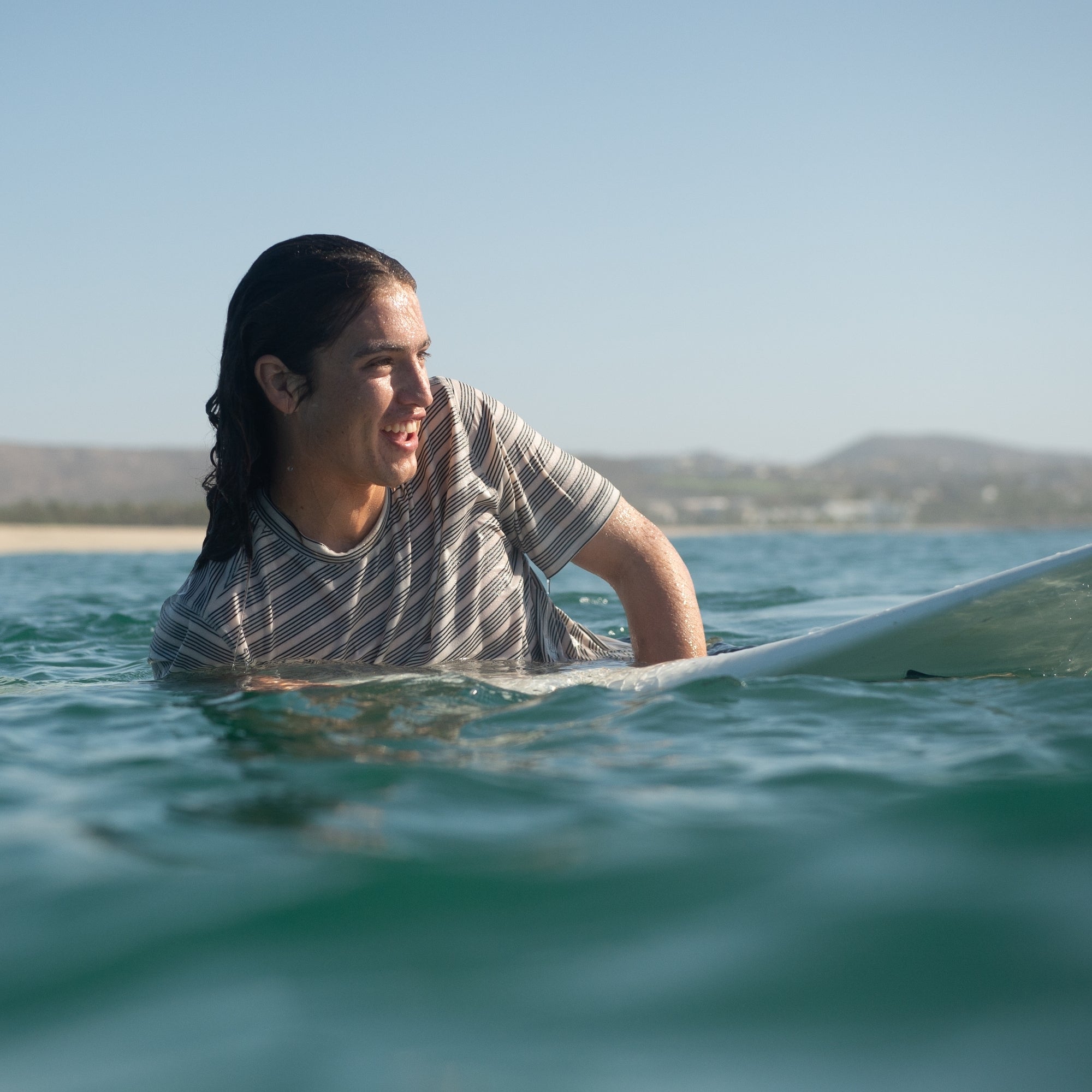 Surfboard and surfing gear on a beach during summer, capturing the essence of adventure and water sports